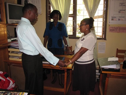 two men and two women holding hands as they pray