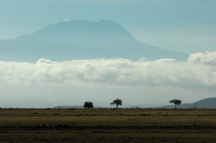 view of mountain surrounded by clouds