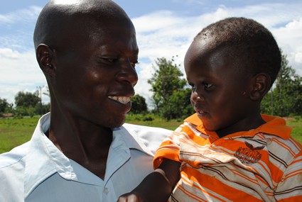 smiling man holding a young child