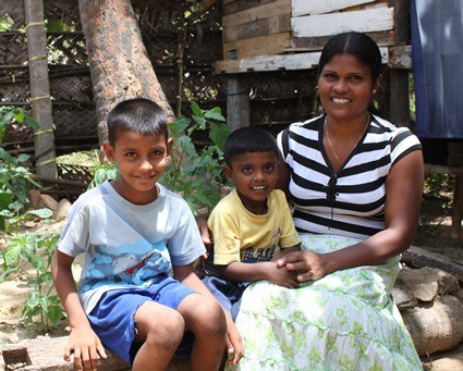 woman sitting with two small boys