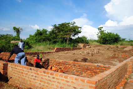 men laying bricks for a house