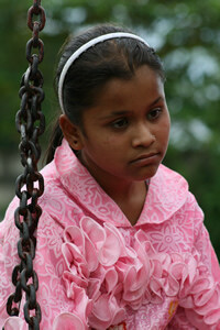 sad looking girl in pink dress