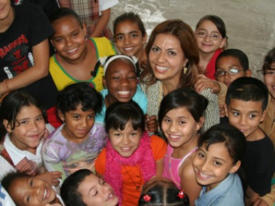 young woman surrounded by group of children