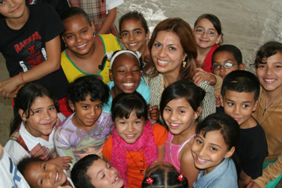 young woman surrounded by group of children