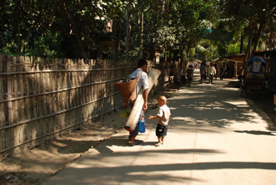 child walking with a man carrying mat