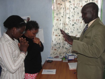 man and two women praying