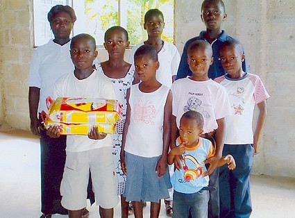 large family holding food gift