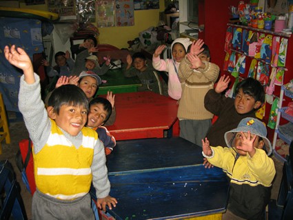 children in classroom waving