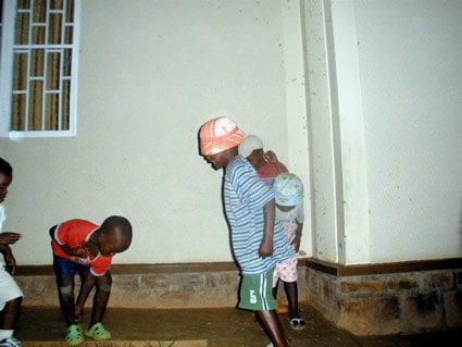 Young children looking at the ground.