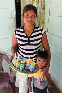 woman holding tray of popsicles