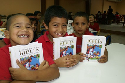 three boys holding bibles