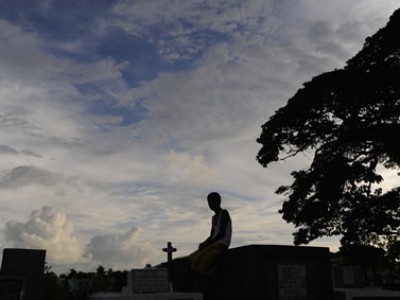 Man sitting in a cemetery.