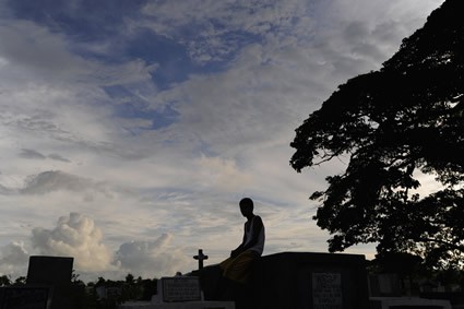 boy sitting in a cemetary