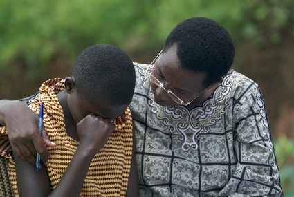 an older person and younger person praying