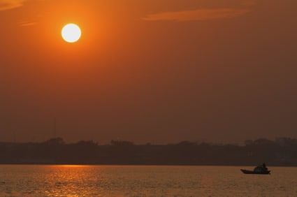 boat on the water with setting sun