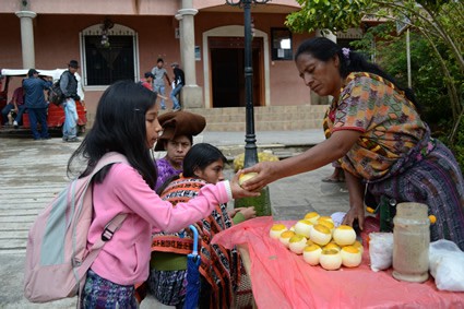 girl in Guatemala buying a snack