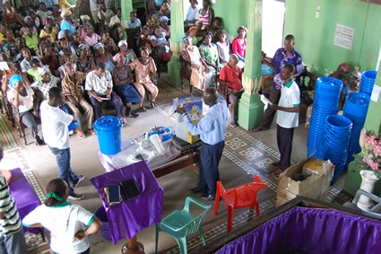 group of people learning about water filtration systems