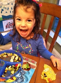 laughing girl sitting at a table