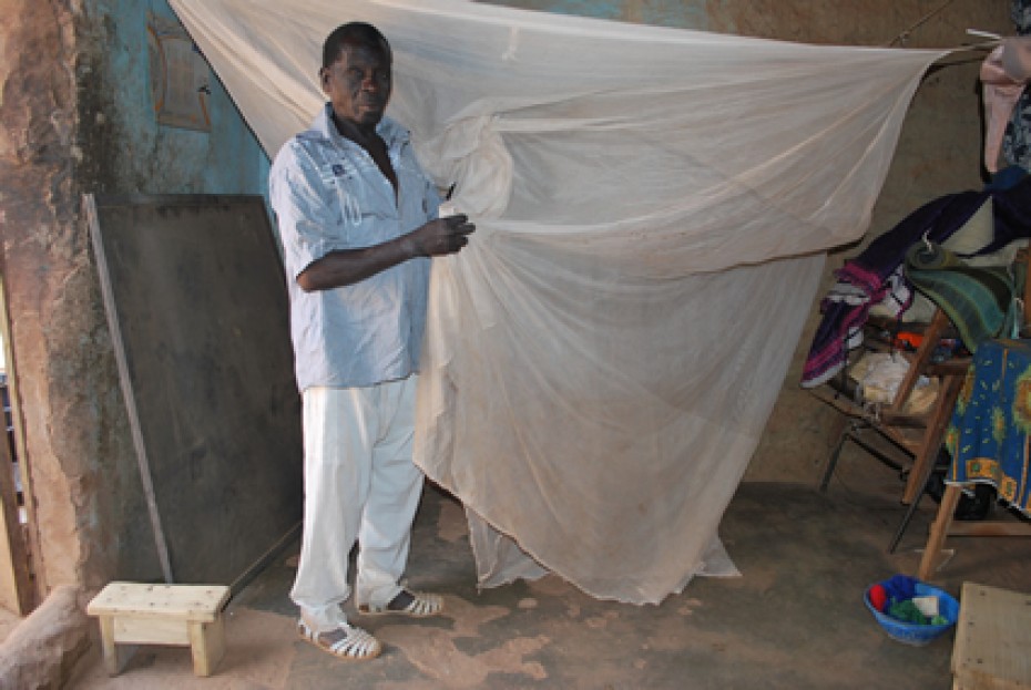 Man holding a mosquito net.
