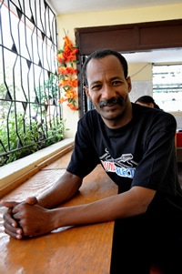 smiling man sitting at a counter