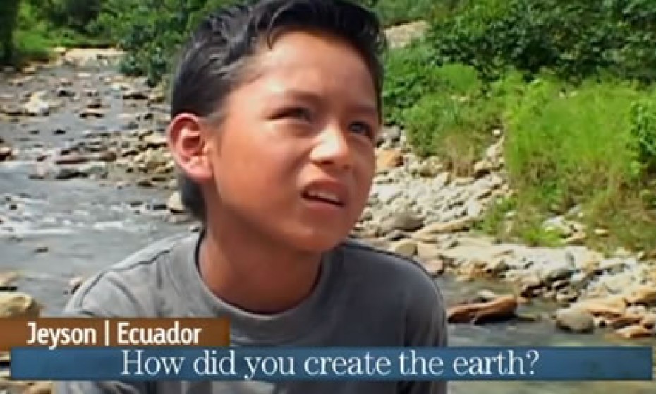 A boy in a blue shirt with a river behind him