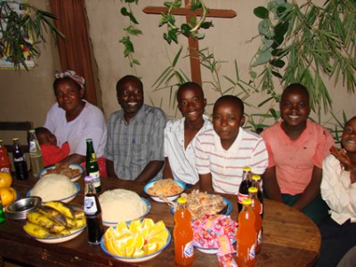 A family sitting at a table with food