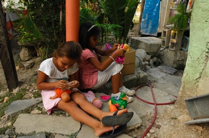 two girls playing with dolls