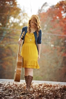 woman walking with guitar