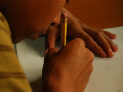 close up of child writing a letter