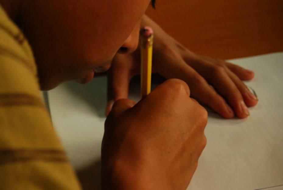 close up of child writing a letter