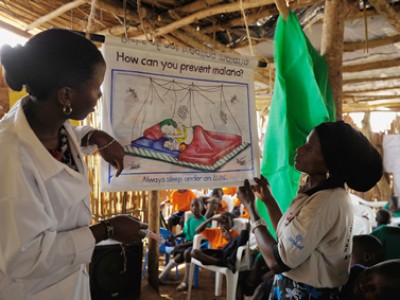 two women giving presentation on malaria prevention