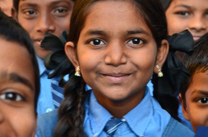 group of smiling children in school uniforms
