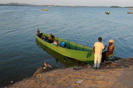 a large row boat next to the shore