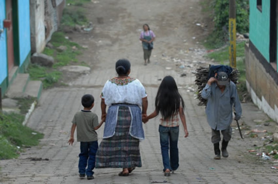 woman walking with two children