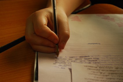 person writing a letter