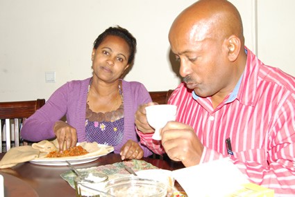 woman and man sitting at a table having a meal