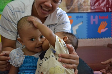 person playing with two small children