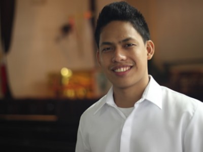 smiling young man wearing a white shirt