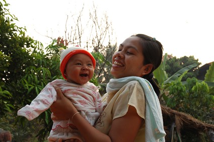 woman holding smiling baby