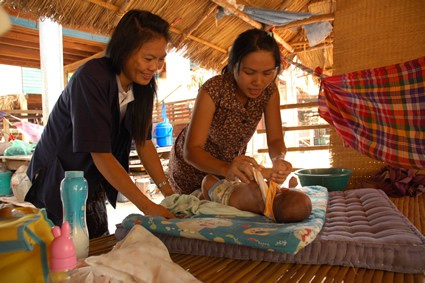 two women tending to baby