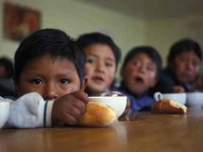 row of children sitting at table