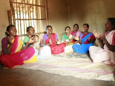 group of women sitting crossed legged on floor