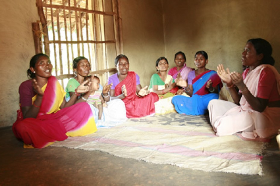 group of women sitting crossed legged on floor