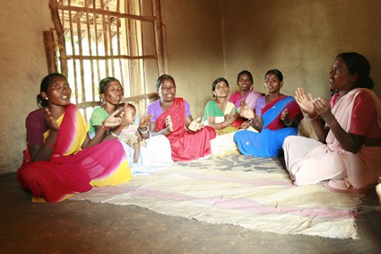 group of women sitting and praying
