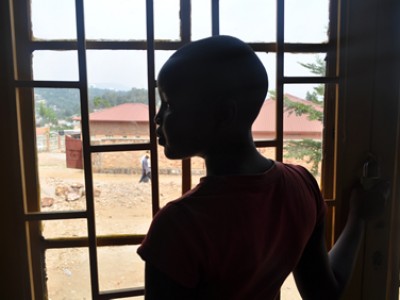 A girl in silhouette standing in front of a window