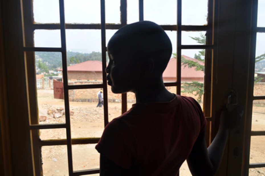 A girl in silhouette standing in front of a window