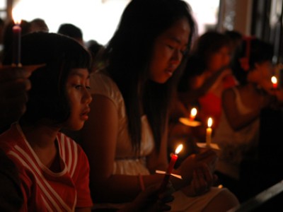 group of young girls holding candles during a service