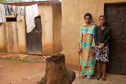 Two women standing next to a building