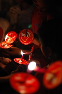 people lighting candles