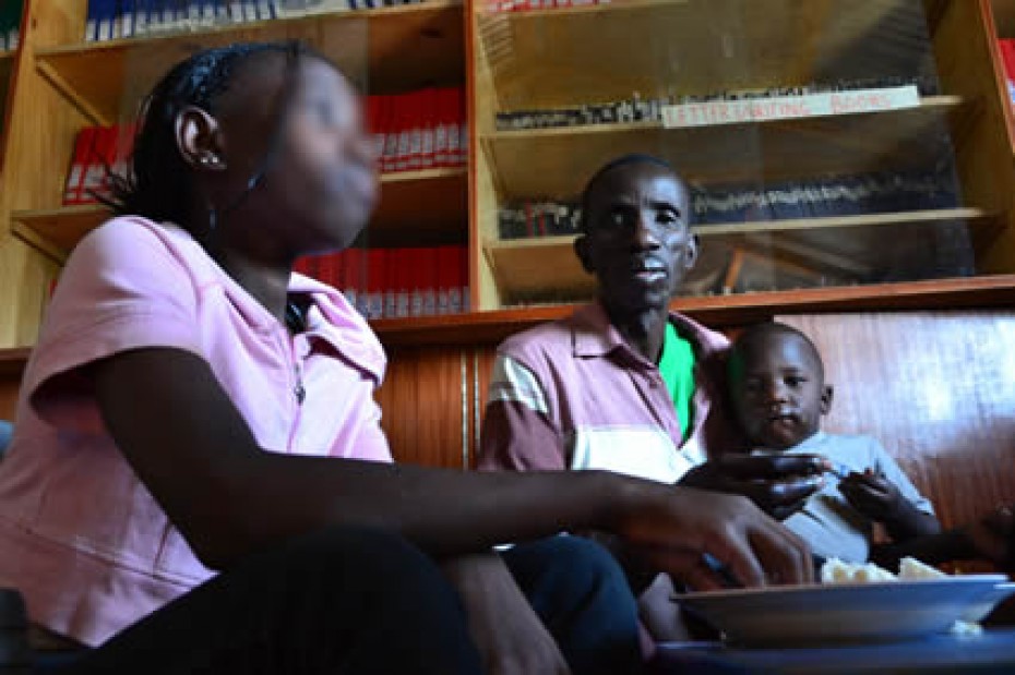 A man and two children sitting inside